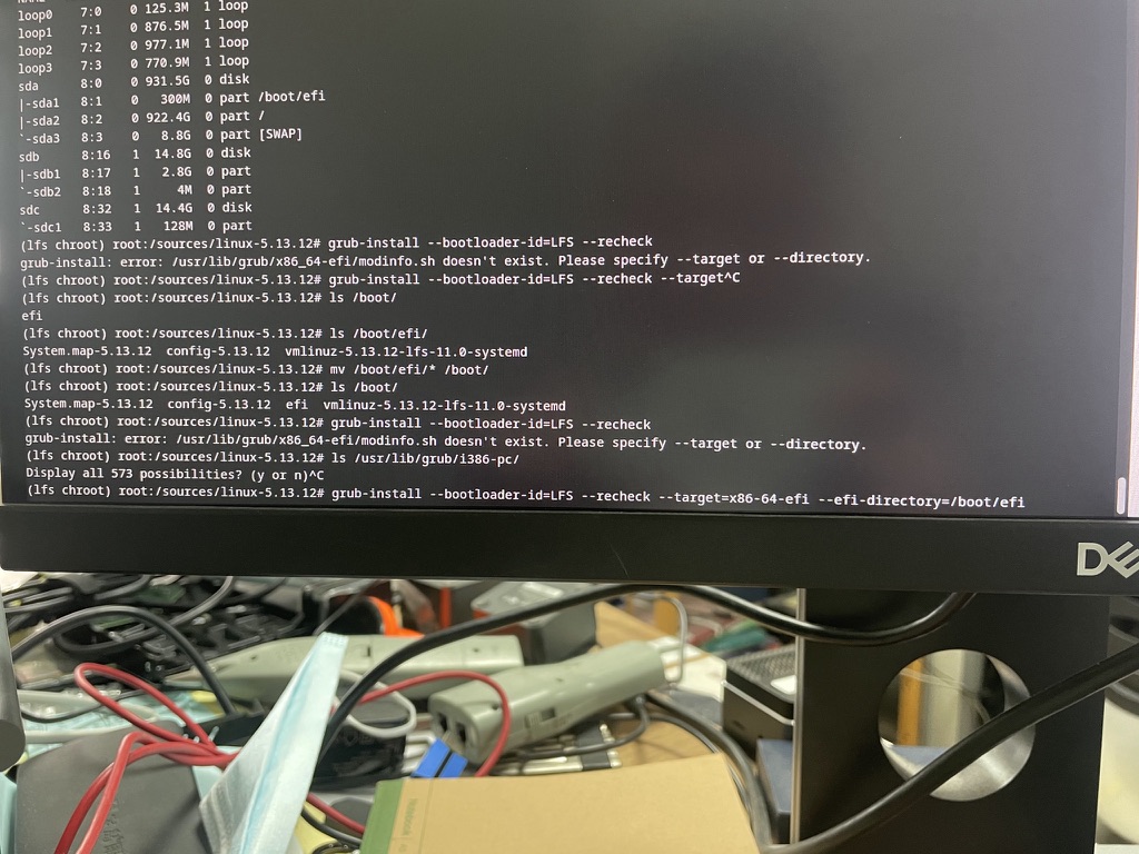 A monitor showing Linux From Scratch grub-install terminal work.