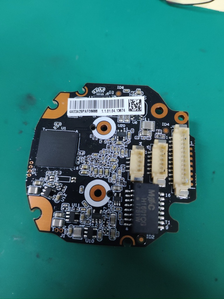 A circuit board removed from the robot car on a green work mat.