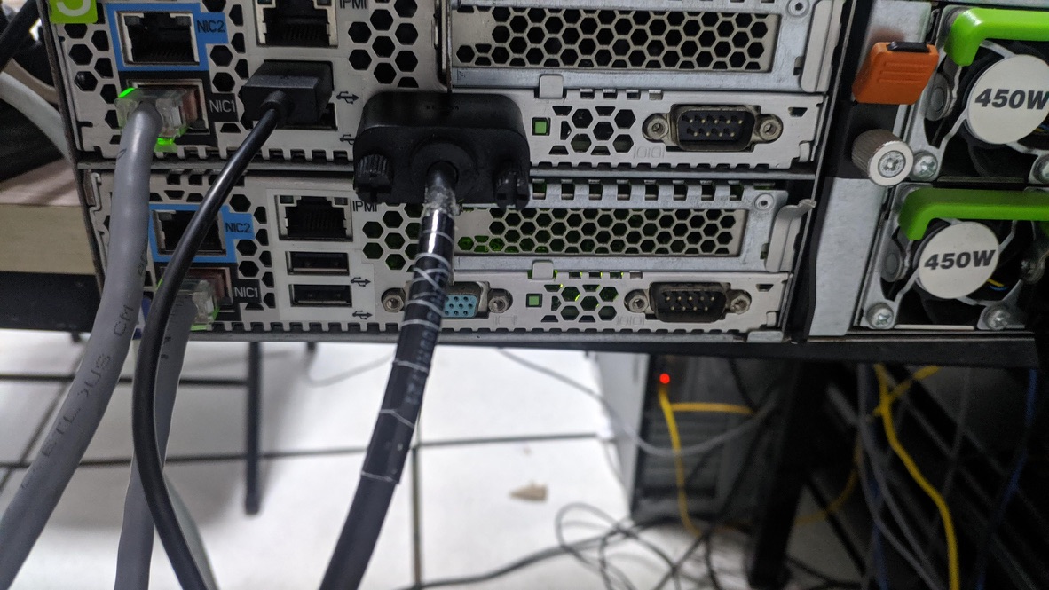 The rear of a server with Ethernet, VGA, and power modules connected.