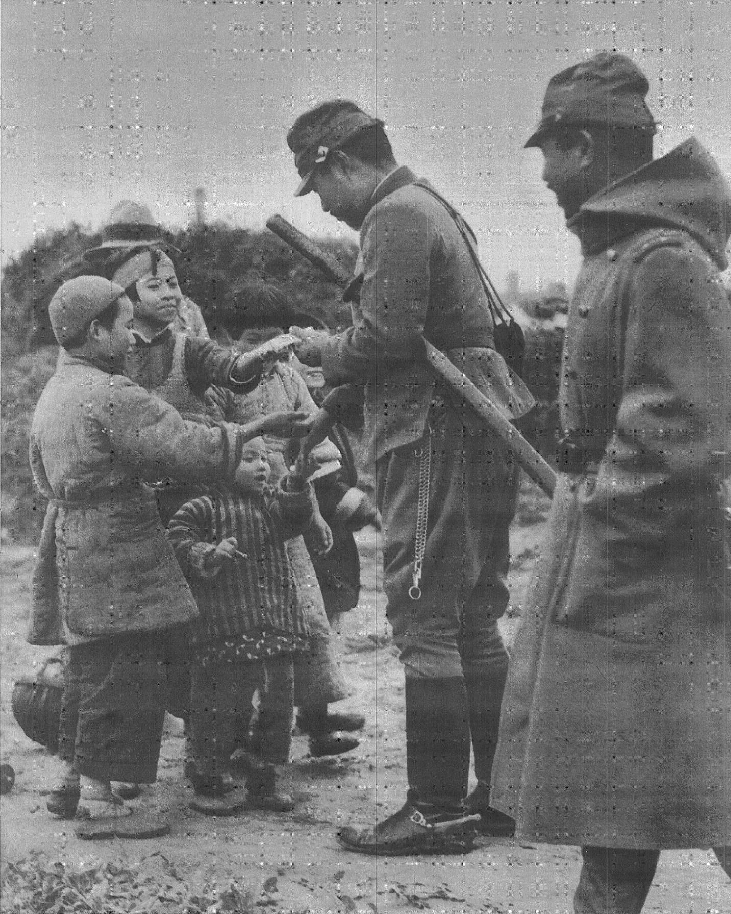 A Japanese military officer giving caramels to a group of Chinese children in Jiangnan on November 6, 1937.