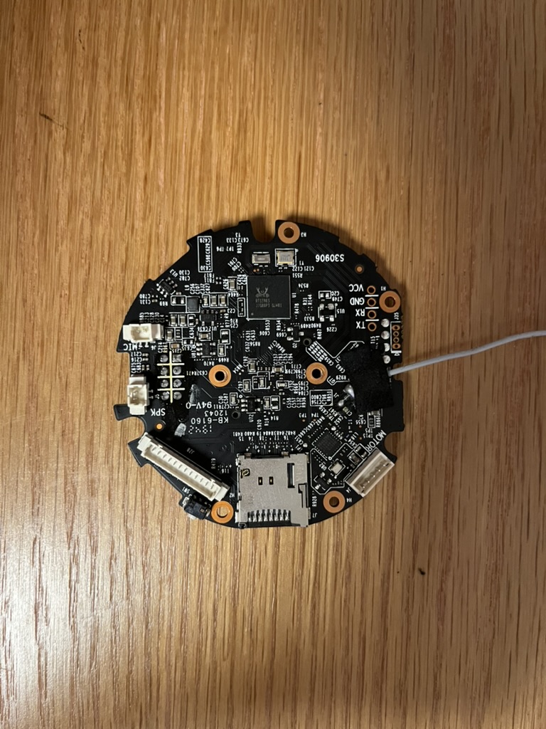 Full circular TP-Link camera PCB on a wooden desk.